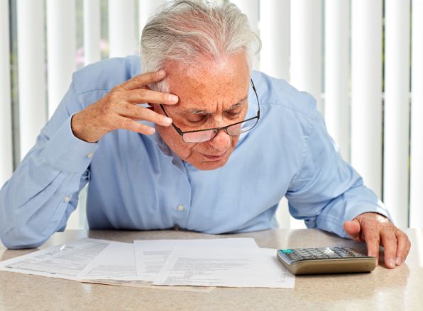 Elderly person working on his finances
